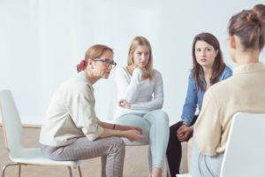 Group therapy session after a woman decided to choose the right rehab